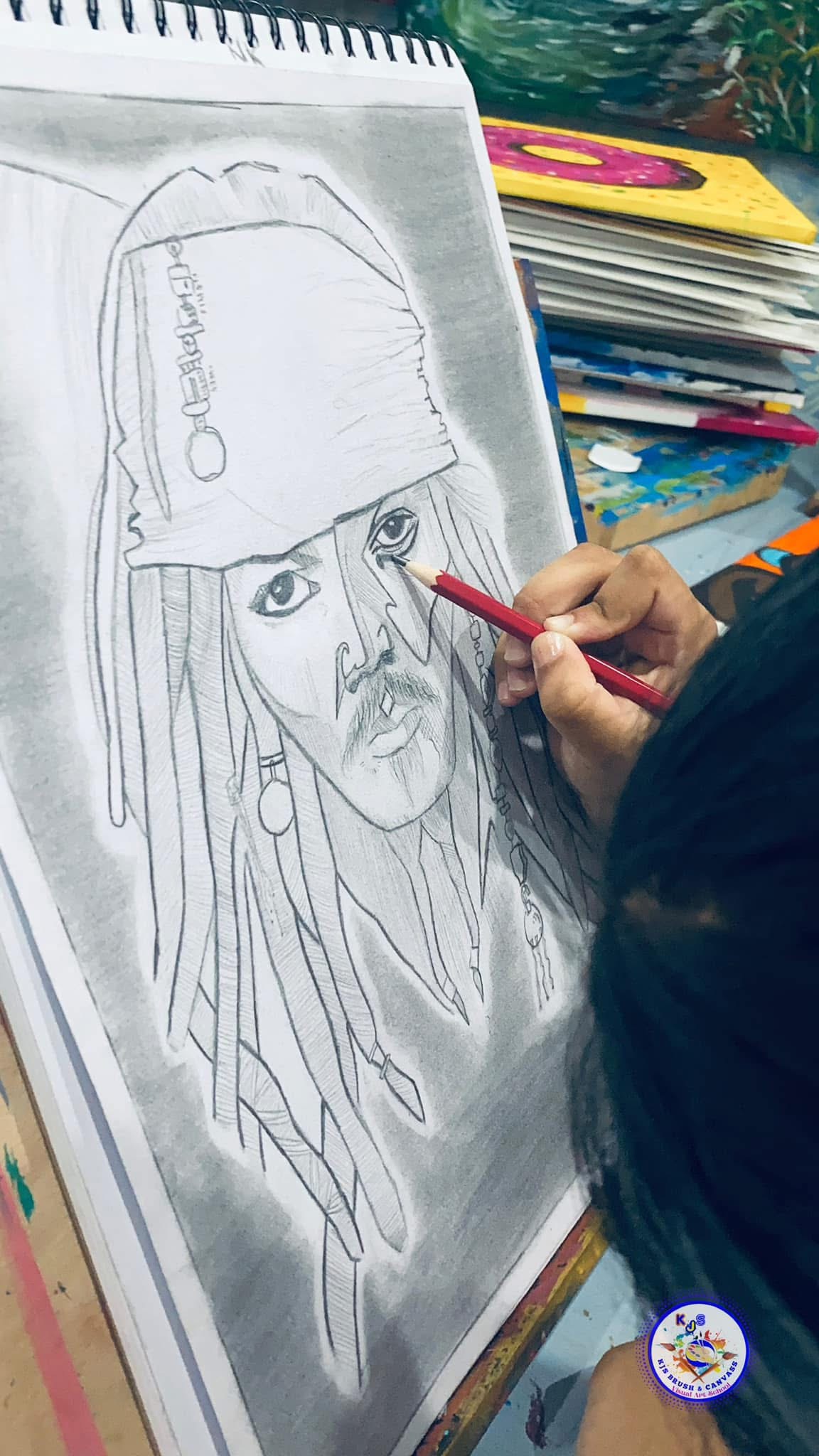 Teenager focusing on detailed sketching